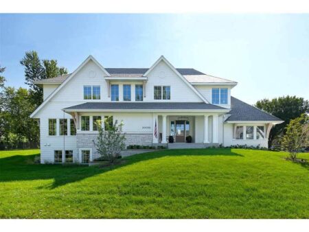 Streeter Built Home with green grass and pool in Cottagewood, Deephaven MN