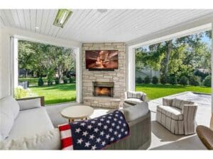 Streeter built covered patio, fireplace, heated, screened, sliding doors, couch, backyard at Lakeview Avenue Deephaven