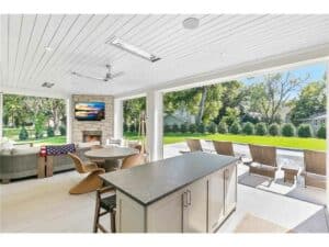 Streeter built covered patio, fireplace, heated, screened, sliding doors, couch, backyard, center island, poolside