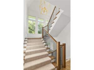 Streeter built stairway, large widonws, carpeted run, natural materials, current style