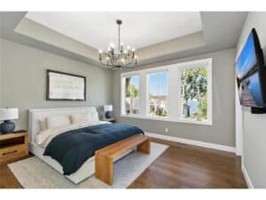 Streeter built primary suite, lakeviews, large windows, television, hardwood floors, oil rub bronze chandelier at Lakeview Avenue Deephaven