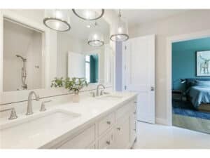 Streeter built jack & jill bath, , tiled floors, white vanity, large mirror