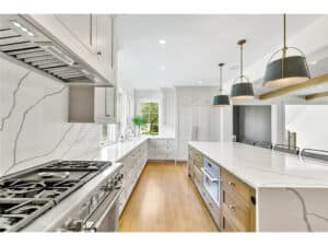 Streeter Built Kitchen, white countertops and backsplash, chef's cooktop