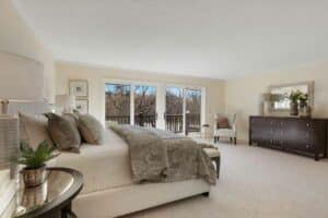 Natural sunlight fills the owner's suite through the sliding glass doors