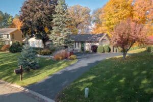 Front Yard of Ranch Style home, Fall Colors in the Trees, Lake in the background